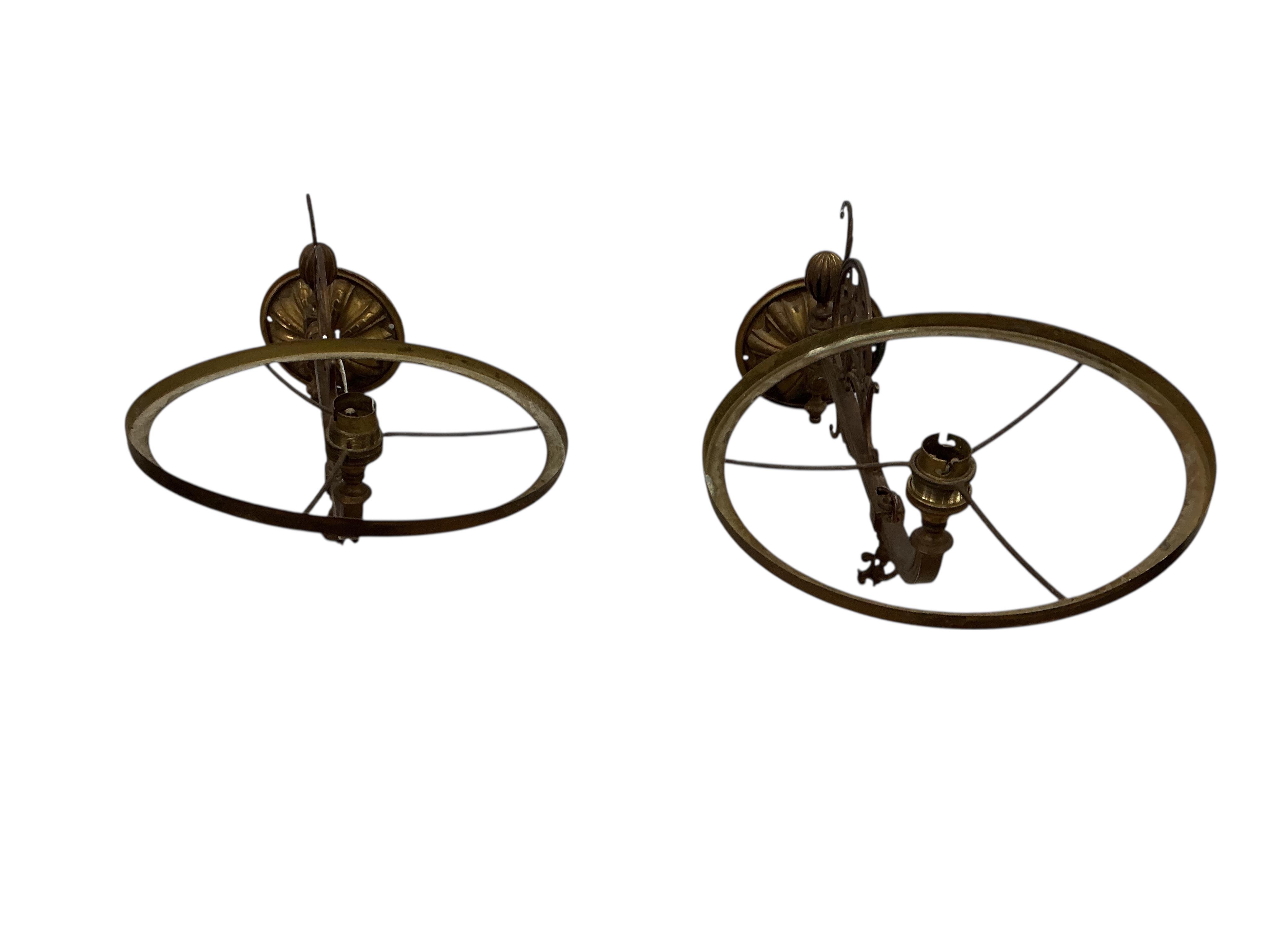 A pair of late Victorian brass wall fitting gas lamps with odd shades (converted), and another electric wall light